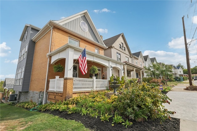 view of front facade with cooling unit and covered porch