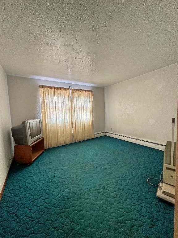 interior space with a textured ceiling, a baseboard radiator, and carpet