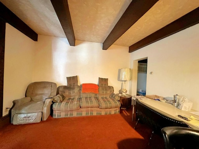 carpeted living room with beamed ceiling