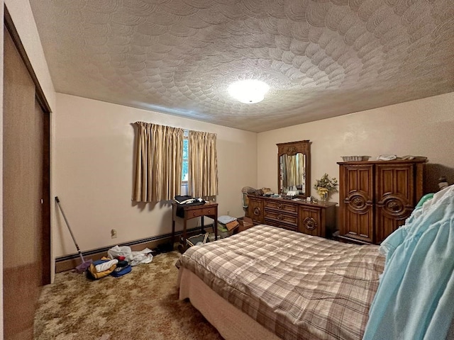 bedroom featuring carpet floors, a textured ceiling, and a closet