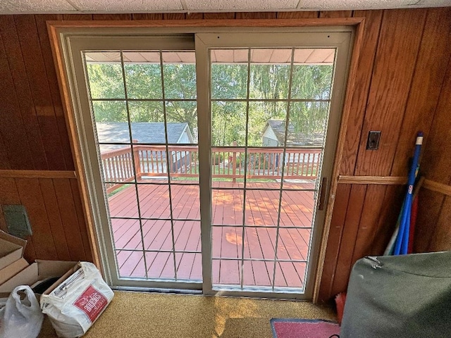 doorway with wood walls