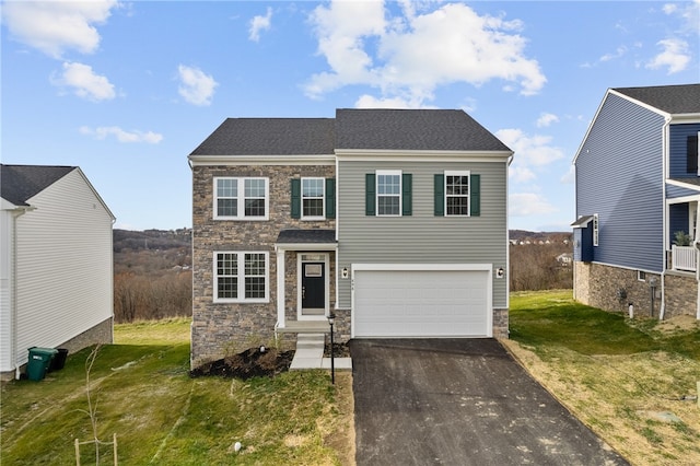 view of front of property with a front yard and a garage