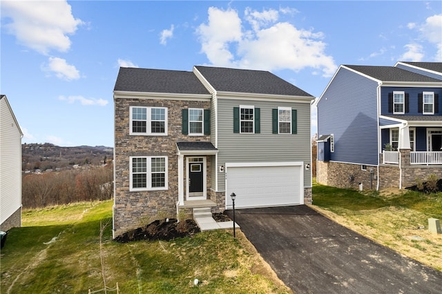 view of front of house featuring a garage and a front yard