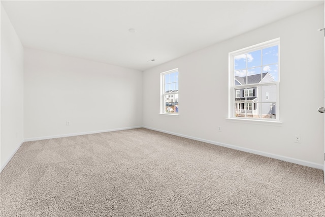 carpeted empty room with a wealth of natural light