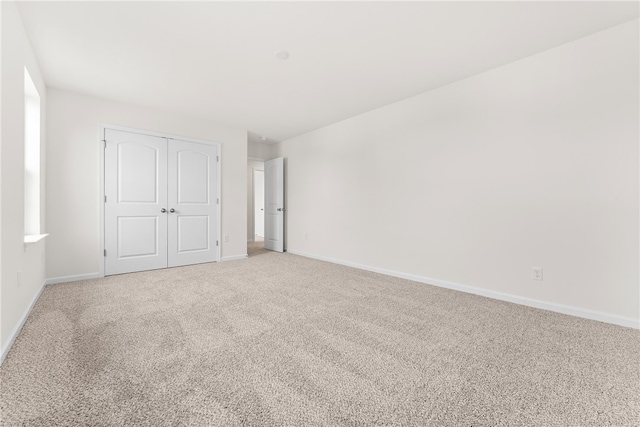 unfurnished bedroom with a closet and carpet