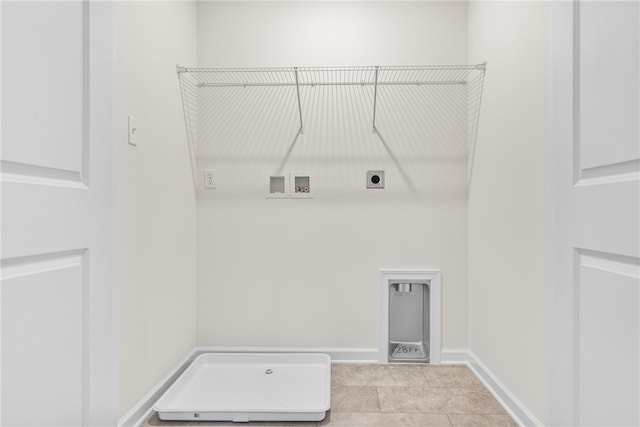 clothes washing area with hookup for an electric dryer, light tile patterned floors, and washer hookup