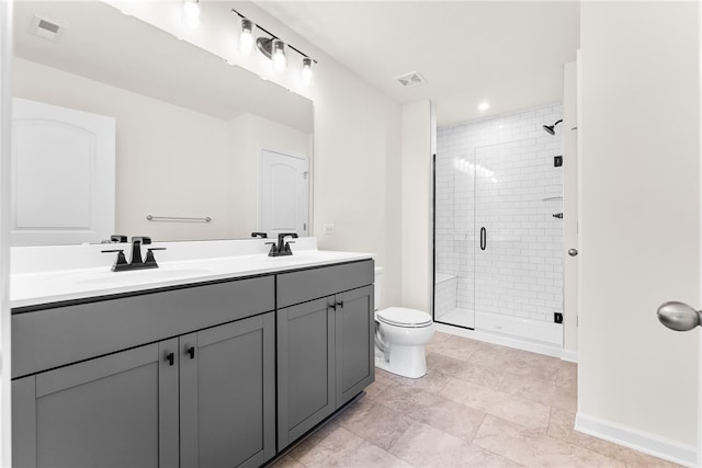 bathroom featuring vanity, toilet, and a shower with door