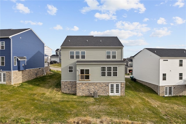 rear view of property with a yard, central AC, and french doors