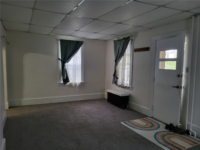 entrance foyer featuring a drop ceiling and carpet