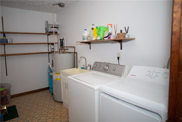 laundry area with separate washer and dryer, water heater, and a textured ceiling