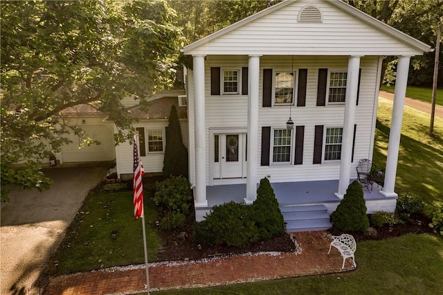 123 Leech Rd, Hempfield Twp Mer, PA 16125 - neoclassical home featuring covered porch, concrete driveway, an attached garage, and a front lawn