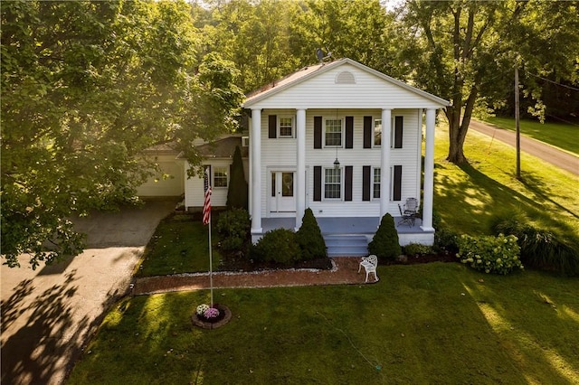 view of front of house with a front lawn and a porch