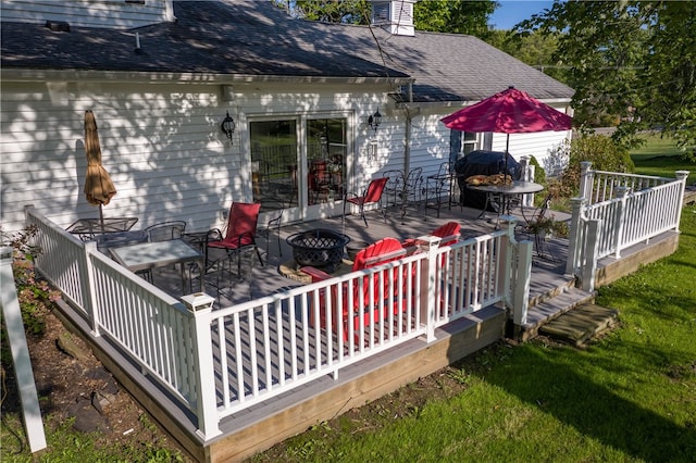 deck featuring a yard and an outdoor fire pit