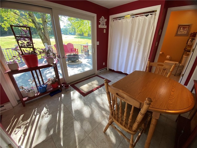 dining area featuring light tile patterned flooring and a baseboard heating unit