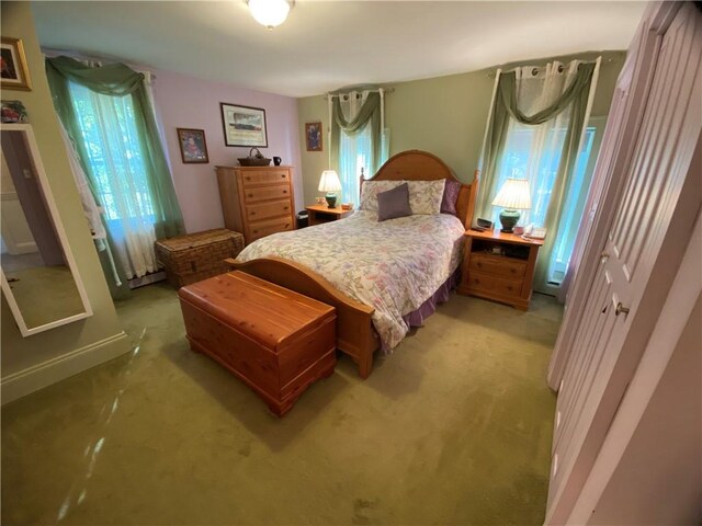 bedroom featuring light carpet and a closet