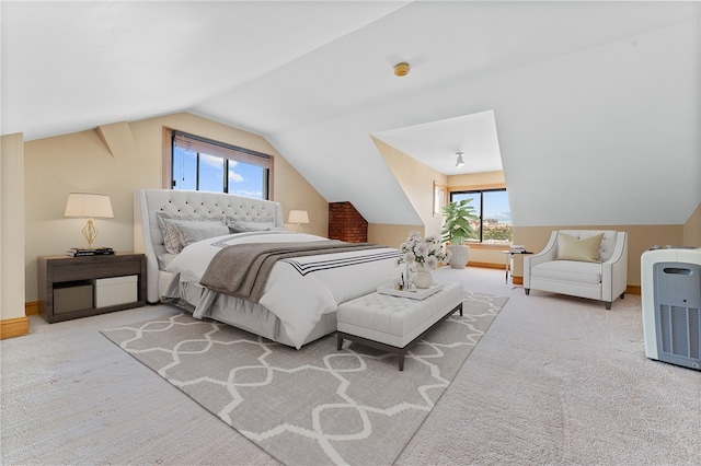 carpeted bedroom featuring lofted ceiling and multiple windows