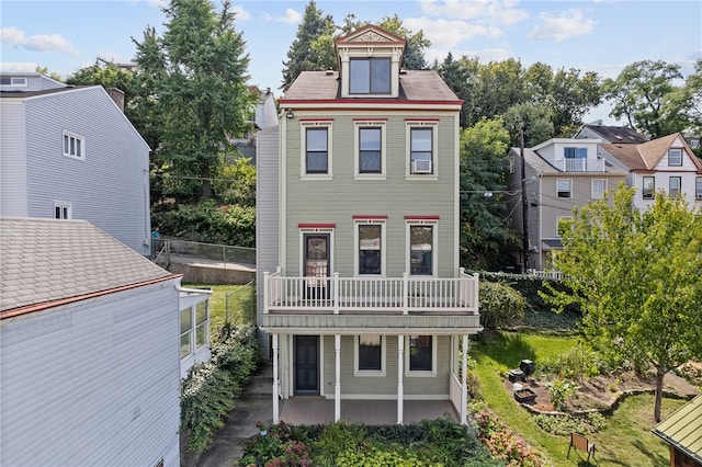 view of front of property with a balcony and a patio