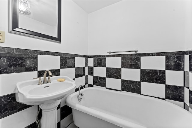 bathroom with tile walls and a bath