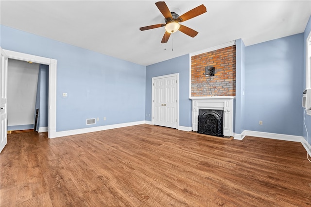 unfurnished living room with wood-type flooring and ceiling fan