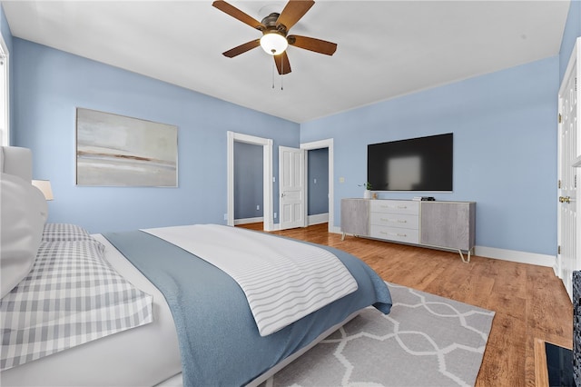 bedroom with ceiling fan and light hardwood / wood-style floors