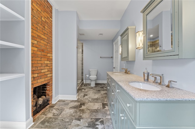 bathroom with vanity, toilet, and a shower with door