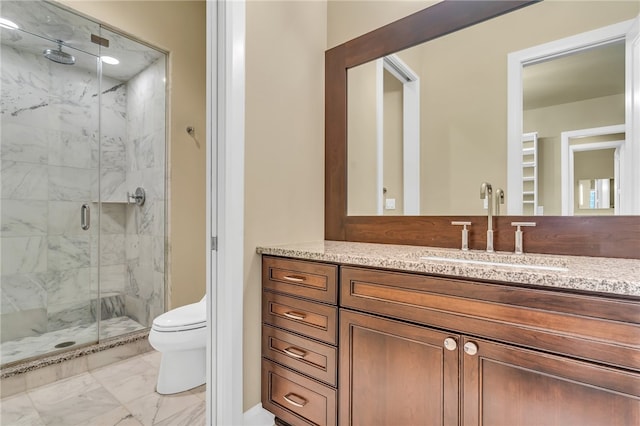 bathroom featuring vanity, toilet, and an enclosed shower