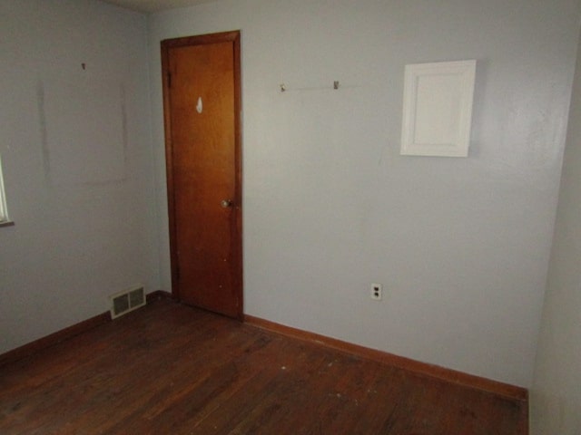 unfurnished room featuring dark wood-type flooring