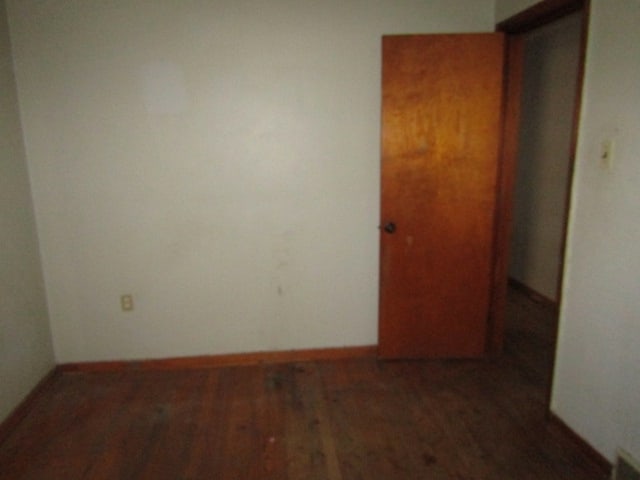 unfurnished room with dark hardwood / wood-style floors