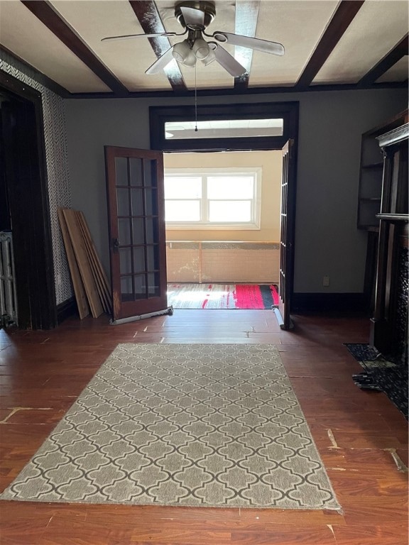 interior space with dark wood-type flooring and ceiling fan