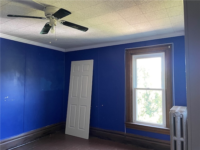 spare room with radiator heating unit, ceiling fan, and ornamental molding