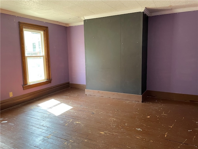 unfurnished room with hardwood / wood-style flooring and ornamental molding