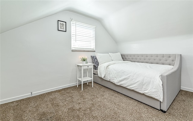 carpeted bedroom featuring lofted ceiling