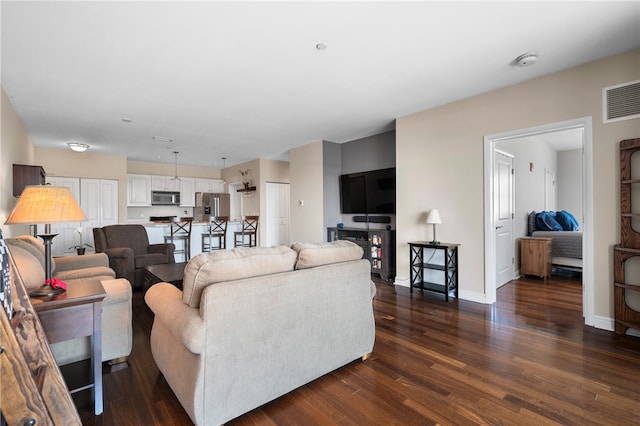 living room with dark hardwood / wood-style floors