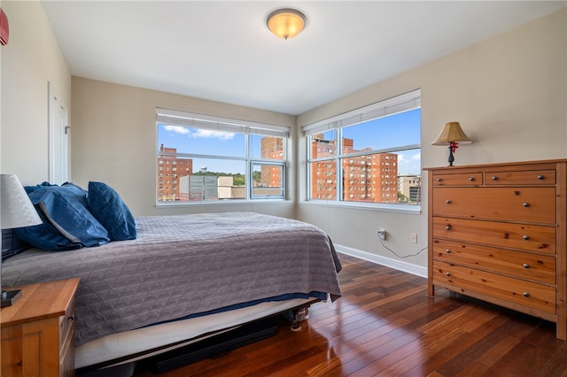 bedroom with dark hardwood / wood-style floors