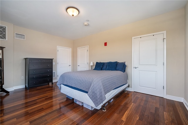 bedroom with dark wood-type flooring