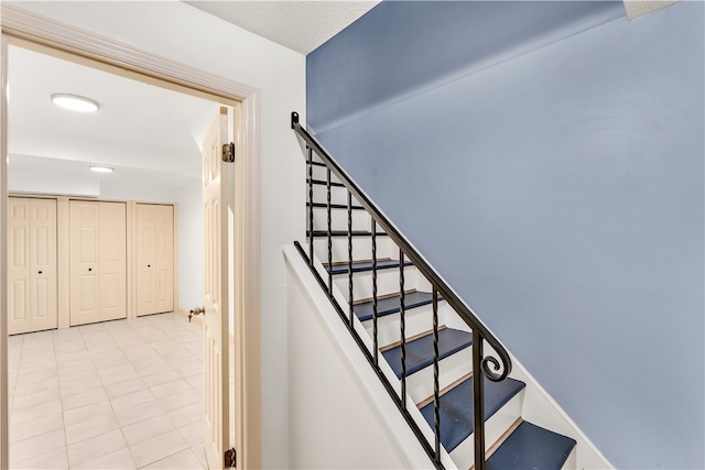 stairway featuring tile patterned floors