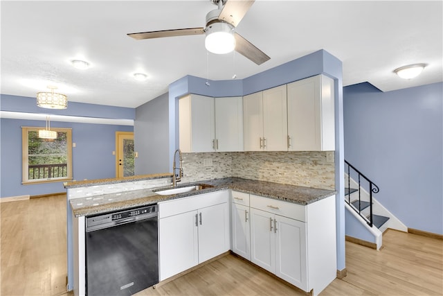 kitchen with black dishwasher, light hardwood / wood-style floors, sink, white cabinets, and ceiling fan