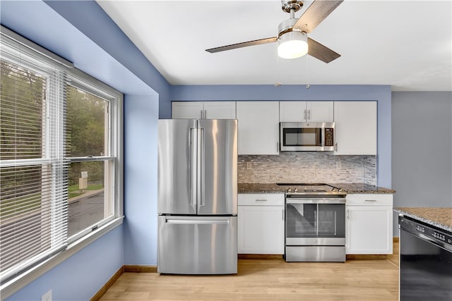 kitchen with light hardwood / wood-style flooring, ceiling fan, stainless steel appliances, and white cabinets