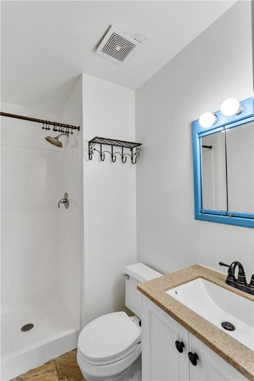 bathroom with a shower, vanity, and toilet