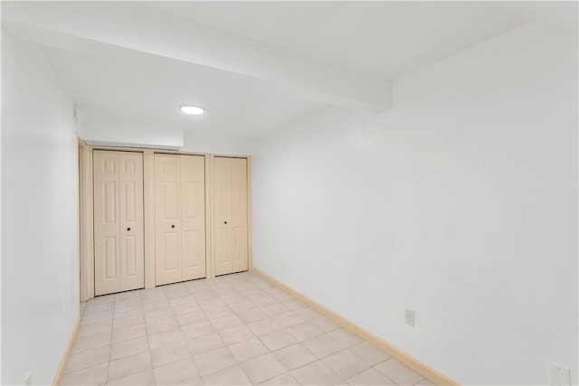 unfurnished bedroom featuring a closet and light tile patterned floors