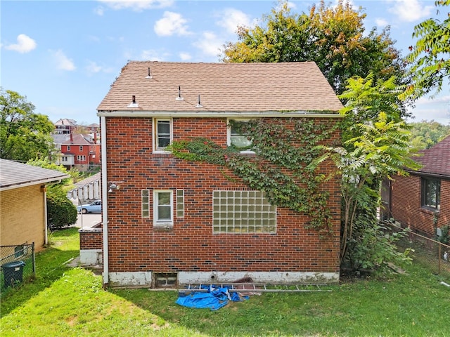 back of property featuring a lawn