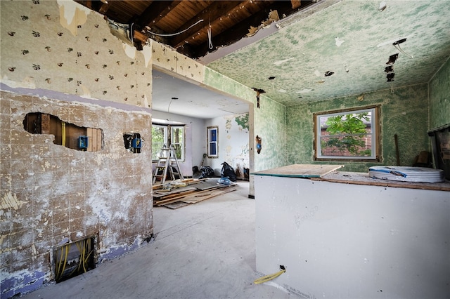 misc room featuring concrete floors and a fireplace