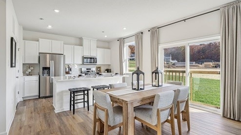 dining area featuring plenty of natural light and light hardwood / wood-style flooring