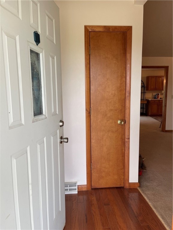 corridor with dark hardwood / wood-style flooring