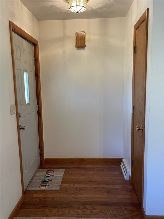 interior space with dark hardwood / wood-style flooring and baseboard heating