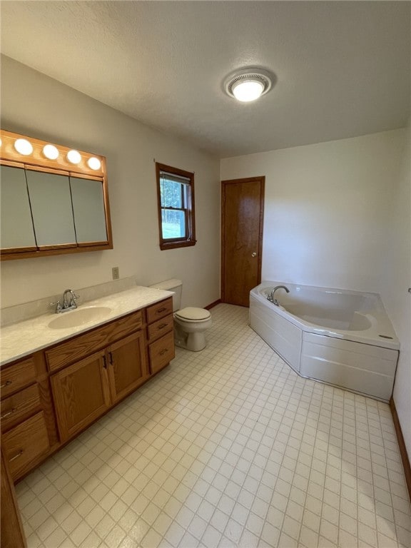 bathroom with vanity, toilet, and a washtub