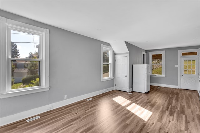 unfurnished living room with hardwood / wood-style flooring