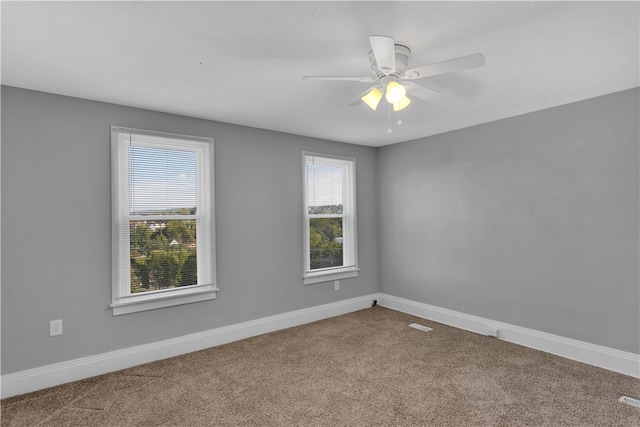 carpeted empty room featuring ceiling fan