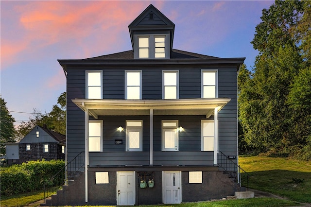 view of front facade featuring a yard and a porch