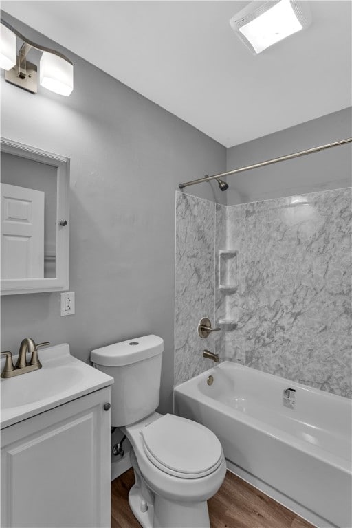 full bathroom with wood-type flooring, vanity, toilet, and tiled shower / bath